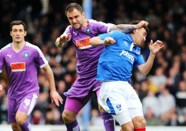 Gary Roberts is elbowed in the head by Plymouth's Peter Hartley Picture: Joe Pepler