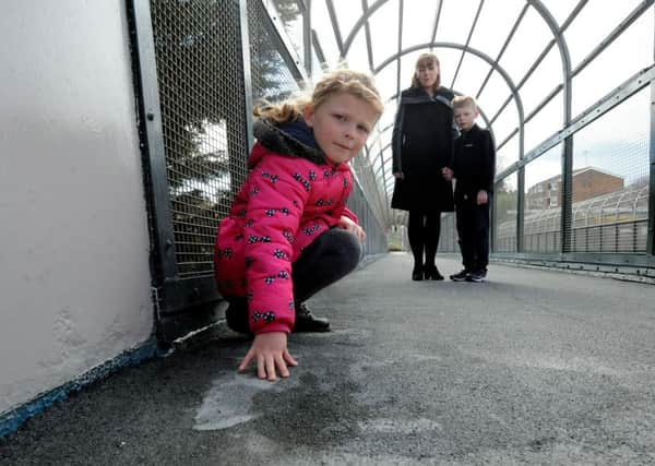 Ria Head, five, showing the lump in the walkway which she tripped over with her mother Carla and brother Asa, seven. Picture: Kate Shemilt