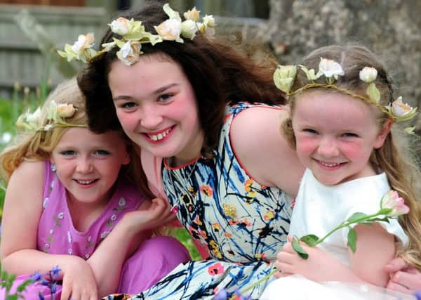 ks16000610-1 May Queen Isobel Dove, ten, with two of her attendants, Lucy Piercce, six, left, and Harriet Rainey, six