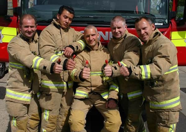West Sussex firefighters pose with their red thumbs for the campaign.