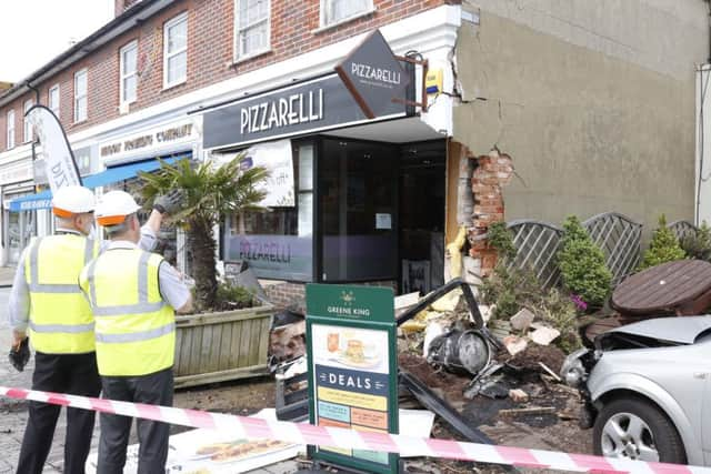 A car has gone into the Pizzarelli takeaway. Photo by Eddie Mitchell.