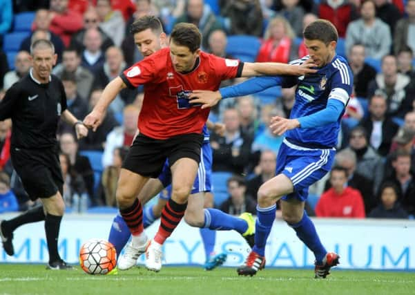 Steve Metcalf challenges Borough's Jamie Taylor in the Sussex Senior Cup final