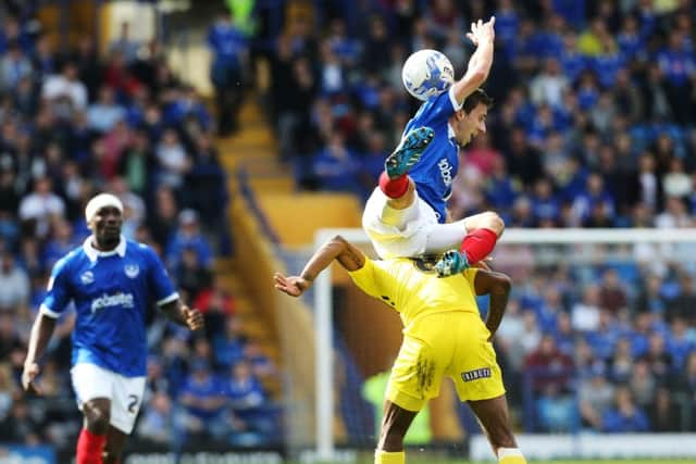 PortsmouthÃ¢Â€Â™s Wes Fogden battles with Plymouth's Jason Banton during the Sky Bet League 2 match between Portsmouth and Plymouth Argyle at Fratton Park, Portsmouth, England on 6 April 2015.