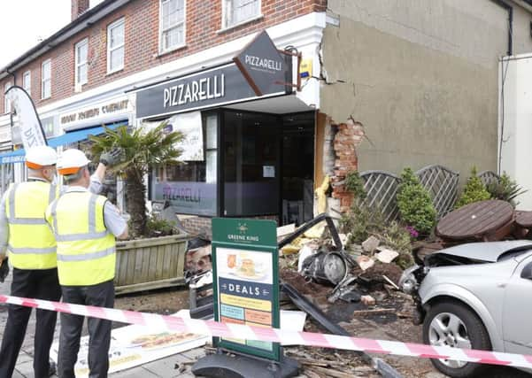 The car and shop after the incident. Photo by Eddie Mitchell.