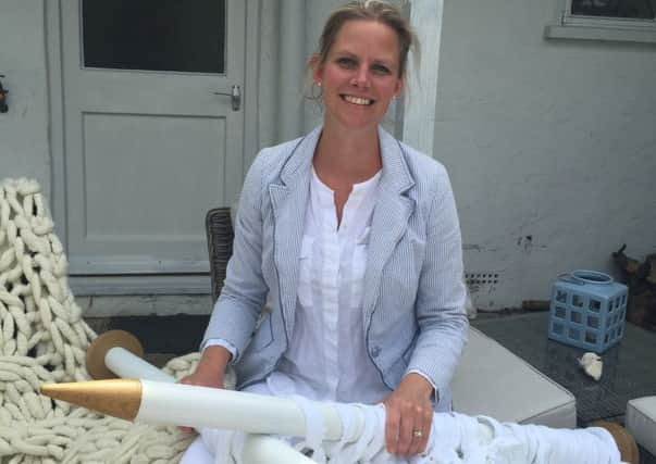 Chichester textile designer Helena Hubbard, busy knitting with her giant 50mm needles