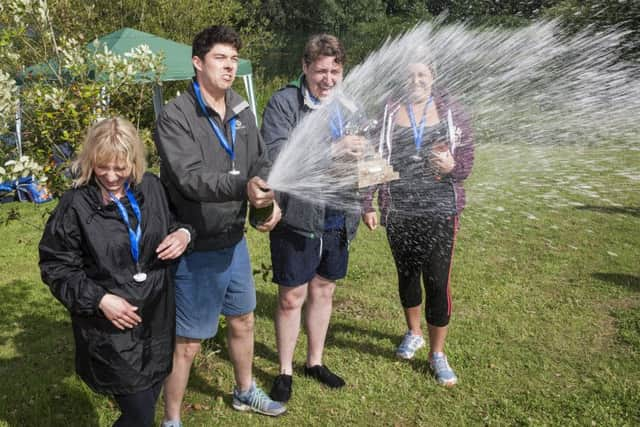 A champagne spray from race winners Henry Adams