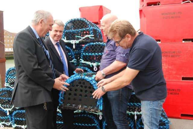 John Malone, Tim Loughton , Jim Partridge and Chris Huxtable looking at the pots' working mechanism, which is an integral part of their design. PICTURE: JOHN PERIAM