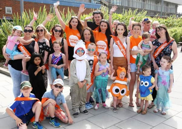 Family and friends gather for the Toddle Waddle along Worthing seafront on Saturday in aid of Meningitis Now. Pictures: Derek Martin DM16130358a