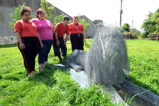 Members next to the new Lion sculpture at Apuldram. Kate Shemilt ks16000862-2 SUS-160725-193752008