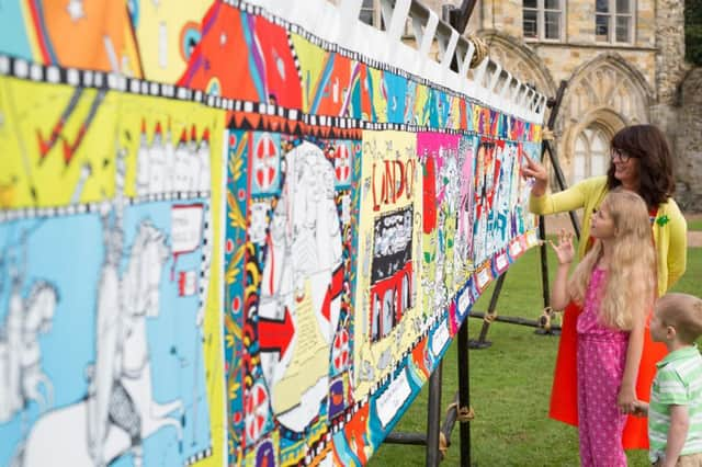 EDITORIAL USE ONLY
L-R Illustrator Liz Pichon (back) Kiera Torrance and Damon Torrance unveil a sequel to the Bayeux Tapestry, commissioned by English Heritage, to mark the 950th anniversary of the Battle of Hastings in 1066, at Battle Abbey in East Sussex. PRESS ASSOCIATION Photo. Picture date: Monday August 1, 2016. The Kids' Tapestry features the top 10 moments in English history since 1066, as voted for by children. Created by Liz, The Kids Tapestry will tour English Heritage sites this summer and children are invited to submit their own illustrations to complete the final panel. Photo credit should read: David Parry/PA Wire SUS-160108-140910001