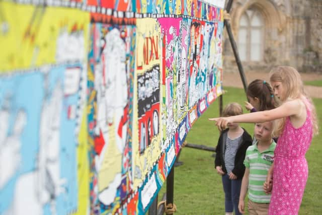 EDITORIAL USE ONLY
L-R Emily Ure, Bella Ure, Damon Torrance and Kiera Torrance take a look at a sequel to the Bayeux Tapestry, commissioned by English Heritage, to mark the 950th anniversary of the Battle of Hastings in 1066, at Battle Abbey in East Sussex. PRESS ASSOCIATION Photo. Picture date: Monday August 1, 2016. The Kids' Tapestry features the top 10 moments in English history since 1066, as voted for by children. Created by Liz, The Kids Tapestry will tour English Heritage sites this summer and children are invited to submit their own illustrations to complete the final panel. Photo credit should read: David Parry/PA Wire SUS-160108-140924001