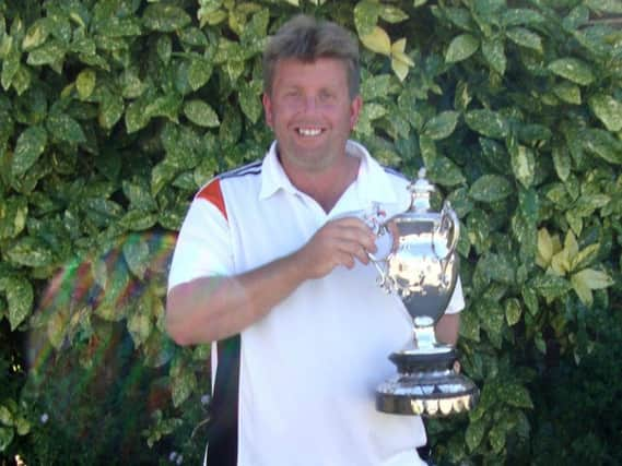 Trevor Roberts clutches the championship singles trophy