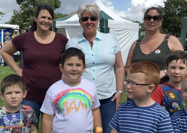 Friends Louise Drury (back centre) and Anna Hampton (back right) at the Burgess Hill Play Day in St Johns Park SUS-160825-125708001