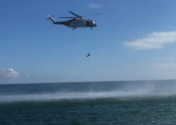 A search and rescue helicopter at the scene in Portholland, Cornwall where another man has died in the sea in a tragic holiday incident.