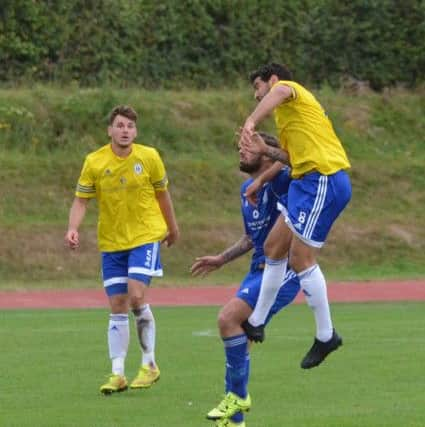 Naim Rouane heads the ball away. Haywards Heath Town v Broadbridge Heath. Picture by Grahame Lehkyj