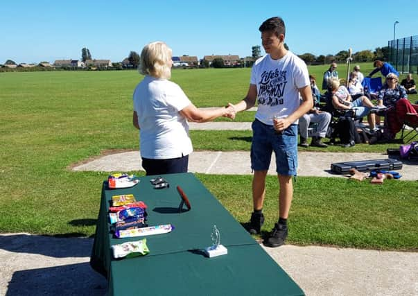 Owen Simons receives his prize at the Bognor club's contest