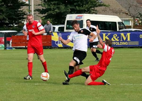 Horsham YMCA's Dean Carden tackles Joe Shelley in Saturday's FA Vase clash. Picture by Roger Smith