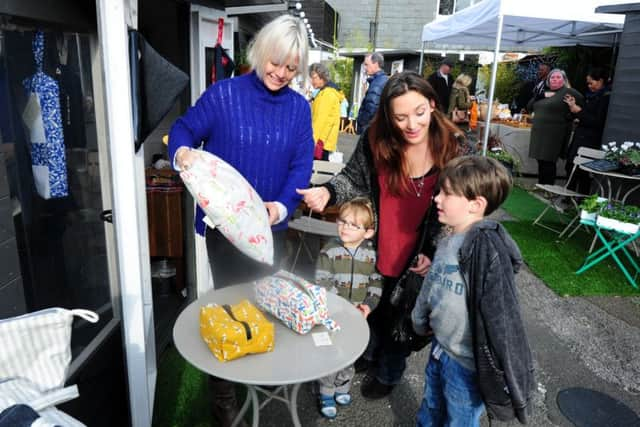 Elizabeth Storton outside her Limpet Design business shop showing off her products