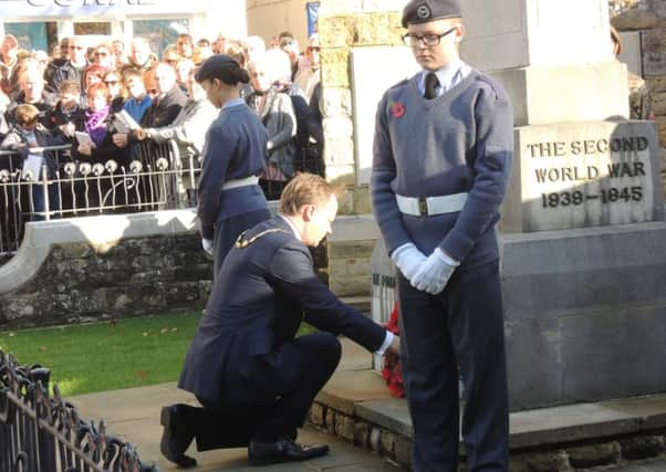 Horsham District Council chairman Christian Mitchell lays a wreath