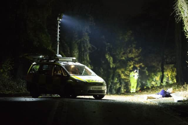 Police at the scene of the crash along the A284