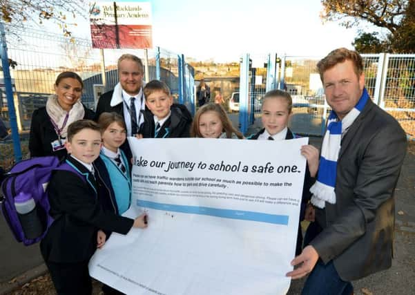 Cllr Andy Batsford and Cllr James Bacon outside Blacklands Academy with members of the school council petitioning against dangerous parking. SUS-161130-092319001