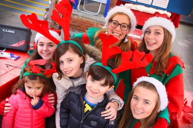 Elves and visitors at the Christmas festival on Saturday. Photo by Derek Martin