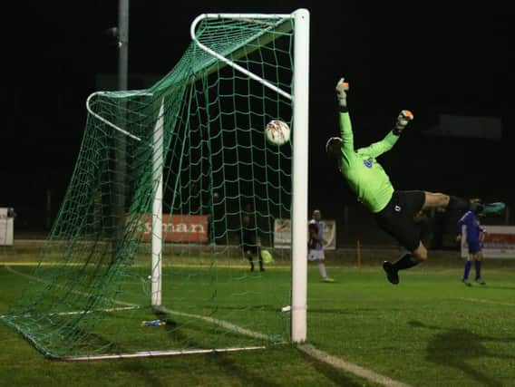 The Greenwich Borough goalkeeper is beaten by Frannie Collin's header for the second Hastings goal. Picture courtesy Scott White