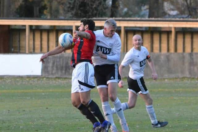 Naim Rouane holds the ball up under pressure. Loxwood v Haywards Heath Town. Picture by Grahame Lehkyj