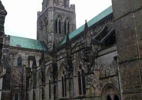 View of Chichester Cathedral behind the statue of Saint Richard