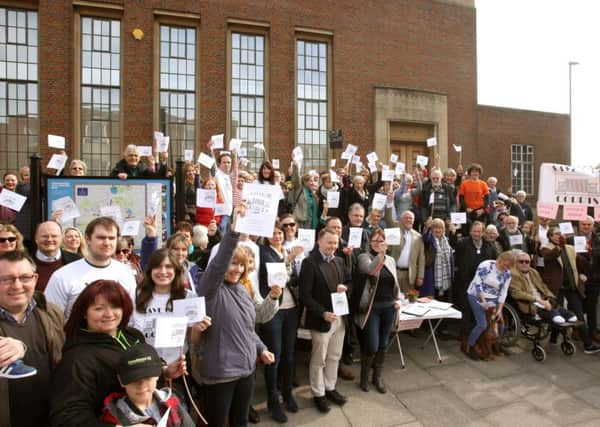 Councillors, lawyers and residents holding a public protest outside the courts earlier this year