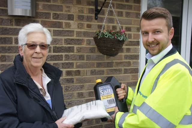 Marion Welshman of Crawley Down Monday Club is given de-icer salt on her doorstep.