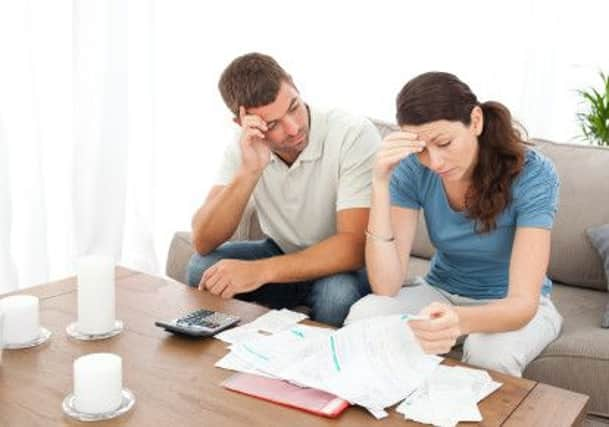 Worried couple doing their accounts in the living room at home SUS-161218-144449001