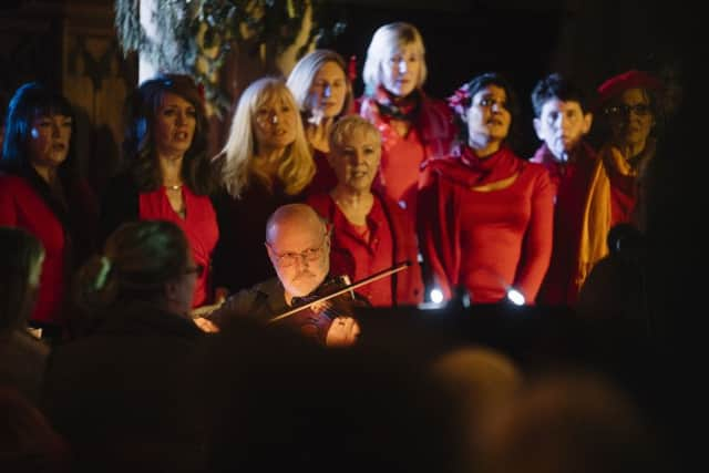 Violinist Garry Blakeley with some of the members of the Vocal Explosion choir SUS-161220-103652001