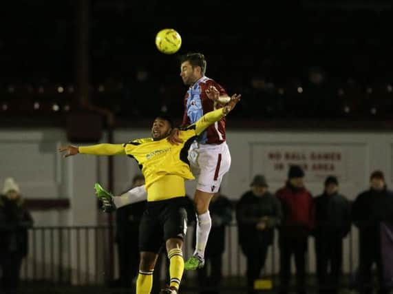 Ollie Rowe wins a header during Hastings United's 1-0 win at home to Faversham Town on Tuesday night. Picture courtesy Scott White