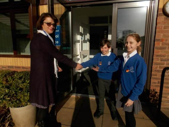 New headteacher, Rachel Nunns, is welcomed by head boySam Clark and head girlSaffie Evershed,