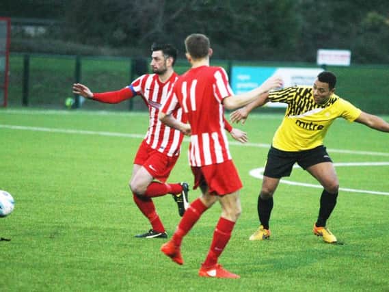 Wes Tate plays a pass for Little Common against Steyning Town. Picture courtesy Derek Martin