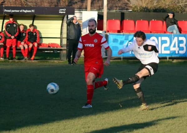 Dan Evans watches on, as does manager Peter Buckland on the sidelines, as Kieron Pamment fires a shot at goal