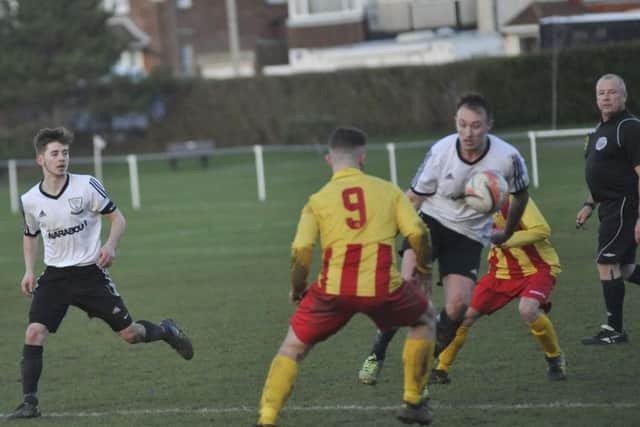 Gordon Cuddington brings the ball under control as Kyle Holden looks on.