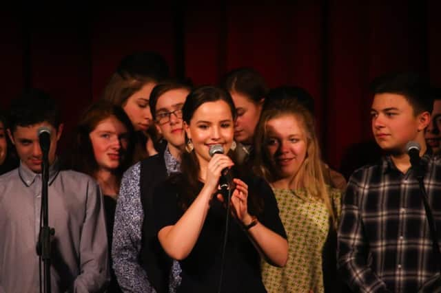 Rosa addresses the audience at the concert