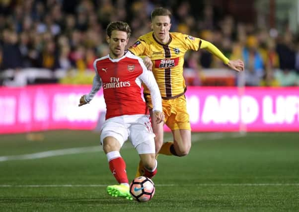 Pompey youngster Adam May, right, in FA Cup action for Sutton United against Arsenal