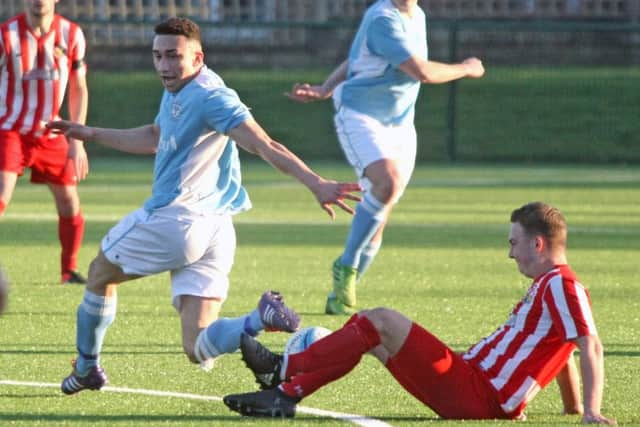 Ashley Kidman tussles for possession during Bexhill United's defeat to Steyning Town. Picture by Derek Martin