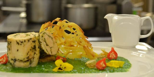 Chicken and herb roulade on spinach and coconut puree with a spicy jus