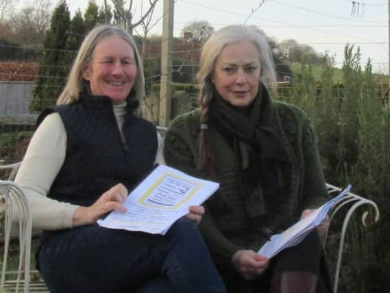 Judges Belinda Wilkins and Sara Hutton Potts discussing poems