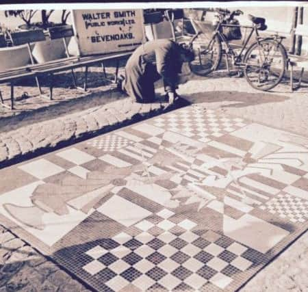 Len Baker working on a mosaic in Queen Square, Crawley SUS-170320-130923001