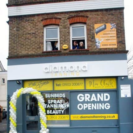 The right window of the Diamond Tanning Studio had been boarded up following the vandalism incident. Picture: Derek Martin