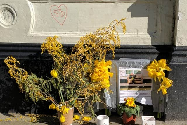 A vase and a memorial to Sid at George Street, in the spot he used to sit