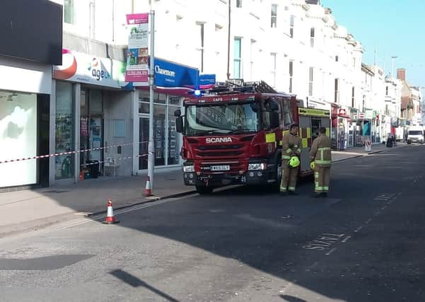 Sussex Police has closed the road after masonry fell from the front of Peacocks, in Chapel Road, Worthing. Picture: Michael Drummond SUS-170328-095053001