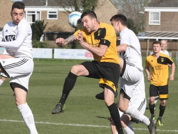 Lee Garnham goes up for header during Saturday's clash with Loxwood. Picture by Derek Martin DM17314277