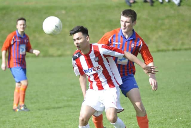 Battle midfielder Trystan Mayhew pressurises an opponent.