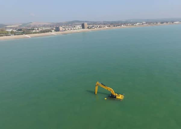 The partially-submerged digger off the coast of Worthing beach, captured by a Phantom drone. Picture: Whitey